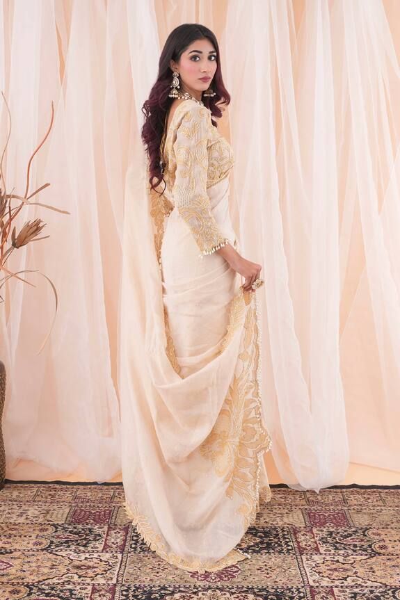 Ivory and beige saree with pearl and cutdana applique work border. Paired with an embroidered blouse with a tasseled hem. - Aza Fashions Elegant White Tissue Silk Pre-draped Saree, Elegant Off White Pre-draped Saree For Festive, Traditional Pre-draped Off White Saree With Sheer Dupatta, Off White Pre-draped Saree With Sheer Dupatta, Designer Georgette Cream Pre-draped Saree, Elegant White Pre-draped Saree For Eid, Designer Off White Saree With Sheer Dupatta, Designer Pre-draped Off White Saree With Sheer Dupatta, Designer Cream Pre-draped Saree In Traditional Style