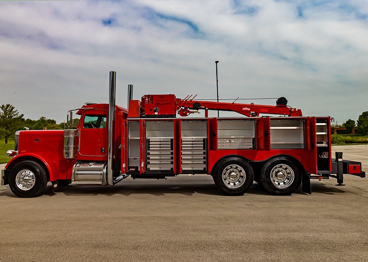 a red fire truck parked in a parking lot