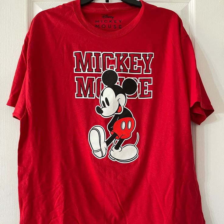 a mickey mouse t - shirt hanging on a door