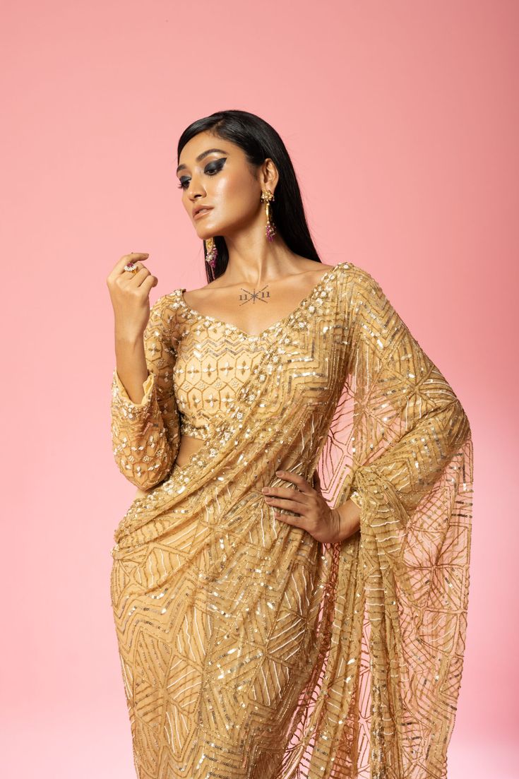 Featuring a golden pre-stitched saree made of pure georgette and net base with intricate hand-embroidery of pearl, sequin, cutdana beads, anchor thread, glass beads all over blouse and saree. Glamorous Pre-draped Saree With Resham Embroidery For Reception, Festive Gold Embellished Pre-draped Saree, Gold Pre-draped Saree With Resham Embroidery For Evening, Gold Pre-draped Saree With Resham Embroidery For Reception, Semi-stitched Sequined Pre-draped Saree For Reception, Festive Gold Pre-draped Saree With Mirror Work, Glamorous Pre-draped Georgette Saree With Dupatta, Festive Gold Pre-draped Saree With Sequins, Gold Georgette Blouse For Receptions