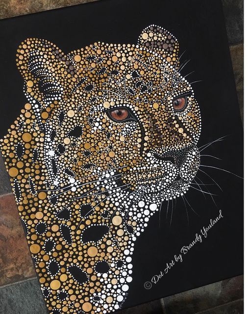 a close up of a painting of a leopard on a black background with gold dots