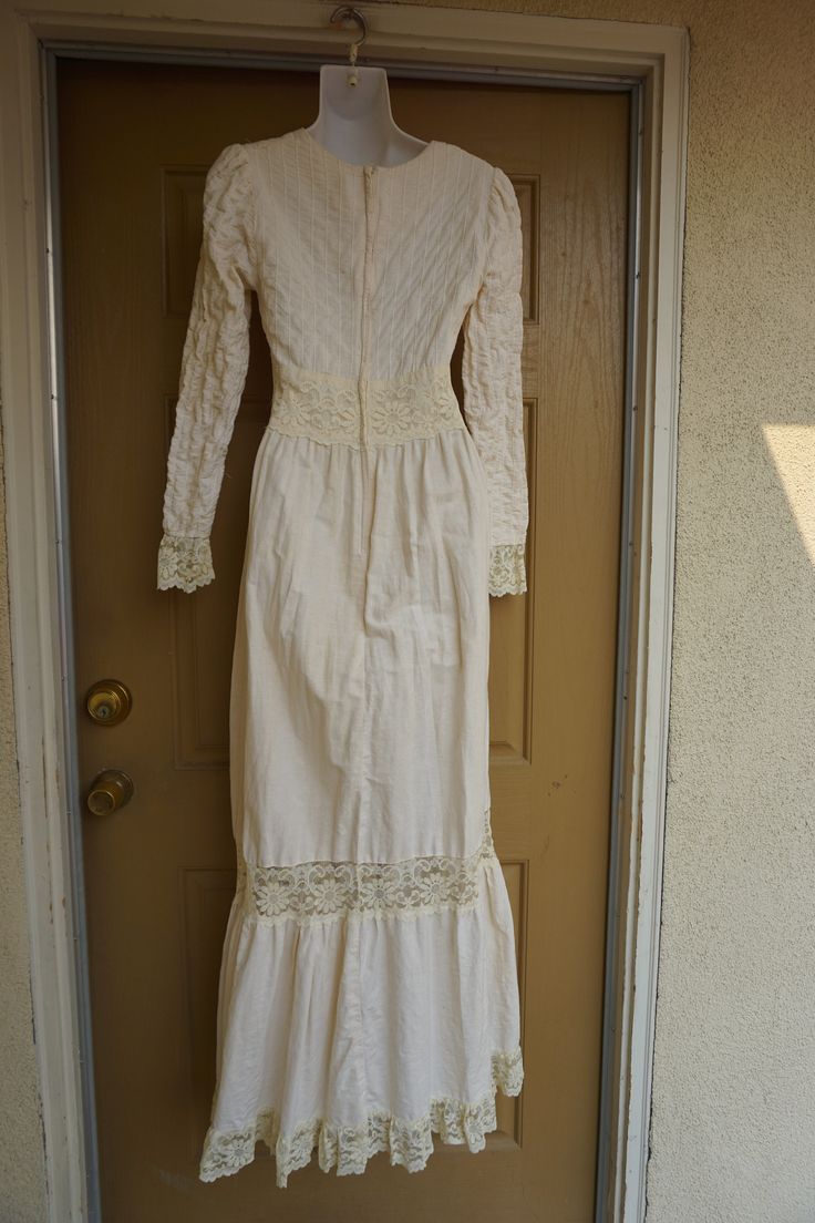 "Size 13 Gunne Sax prairie dress fits smaller - please see measurements. Zips in the back with adjustable tie at the back of the waist. Condition - has one small spot mid skirt to the side - see last photo. Measurements taken across front lying flat 18\" across front armpit to armpit 14\" across front of waist (ties tighter) 59\" length" Long Sleeve Maxi Dress With Lace Trim For Wedding, Fitted Full-length Dress With Lace Sleeves, Elegant Fitted Long Sleeve Prairie Dress, Fitted Full Length Dress With Lace Sleeves, Fitted Floor-length Maxi Dress With Lace Trim, Full Length Fitted Dress With Lace Sleeves, Victorian Long Sleeve Dress For Vintage Events, Vintage Full-length Maxi Dress For Wedding, Vintage Long Sleeve Maxi Dress For Wedding