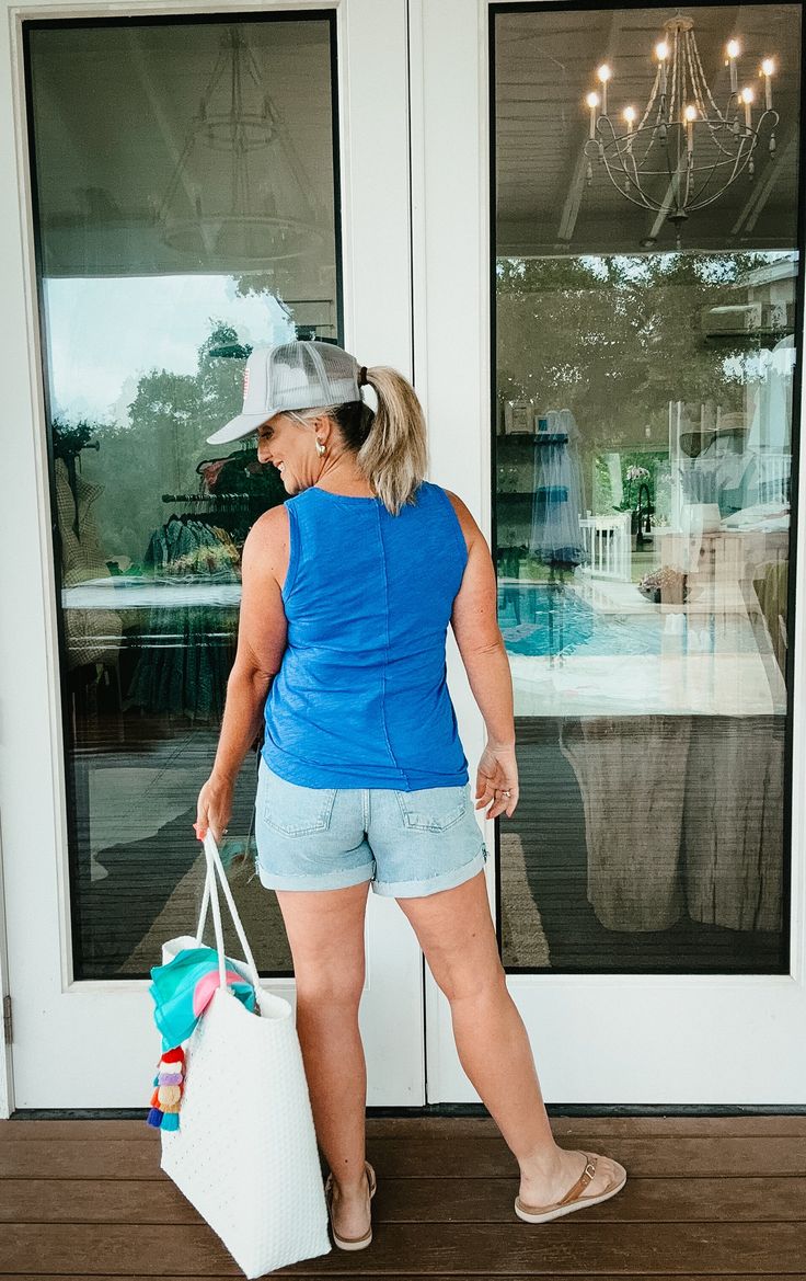 This ultra-comfy tank features a v-neck and front seam detail for added interest. In coveted summer shades, you'll have this seasonal basic in regular rotation this summer and beyond. True to size for a more fitted look or size up 1 for a more relaxed look. Janell is 5’5” and a size 6 wearing size medium (size up). Dana is 5’4” and a size 12 wearing size large (true size). *100% Cotton *Body Length: 25"/26" *Slubbed Jersey XS: 0-2 S: 4-6 M: 8-10 L: 10-12 XL: 14 *Items ending in $.98 indicate cle Nickel And Suede, Summer Shades, Small Town Girl, Short Denim Skirt, Athleisure Wear, Top Graphic Tees, Easy Summer, Hat Shop, Summer Collection