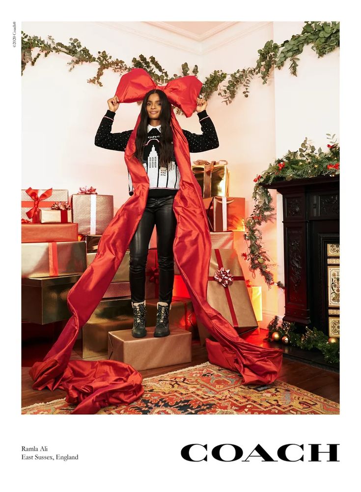 a woman standing on top of a pile of presents