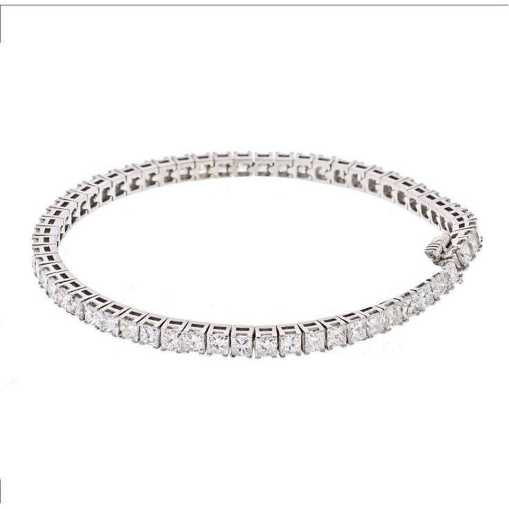 Indulge in the timeless elegance of our 14K White Gold 7 Carat Princess Cut One Line Tennis Bracelet. This exquisite piece is meticulously crafted in 14K white gold and adorned with a dazzling array of 7.70 carats of princess cut diamonds. Every diamond is carefully selected for its exceptional brilliance and fire, creating a captivating sparkle that will mesmerize onlookers.Designed to be worn effortlessly from day to night, this tennis bracelet is 7 inches long, draping gracefully around your White Platinum Diamond Bracelet With Accents, Exquisite Platinum Diamond Bracelet With Brilliant Cut, Exquisite Platinum Tennis Bracelet With Diamond Accents, Luxury Platinum Diamond Bracelet With Brilliant Cut, White Platinum Diamond Jubilee Bracelet, White Platinum Jubilee Diamond Bracelet, Timeless White Bracelets With Single Cut Diamonds, Dazzling Platinum Tennis Bracelet With Jubilee Style, Luxury Platinum Tennis Bracelet With Single Cut Diamonds