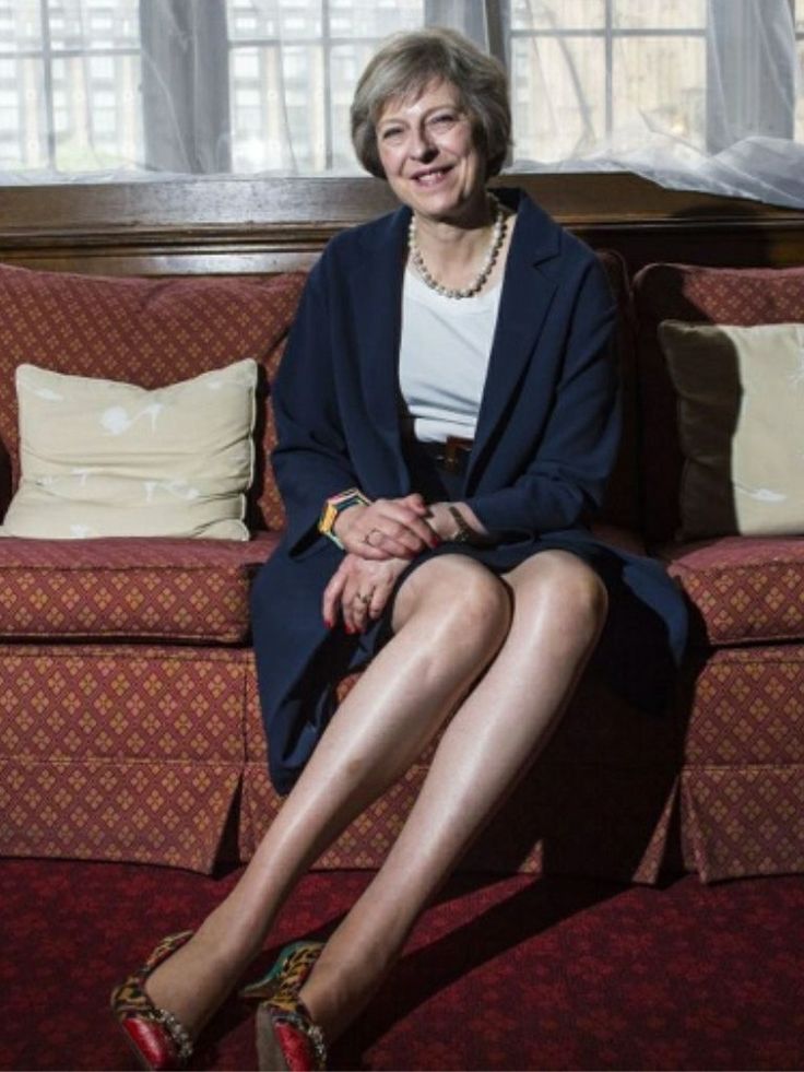 a woman sitting on top of a red couch