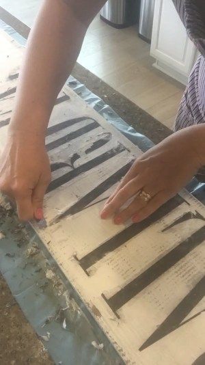 a woman is cutting up some wood with scissors