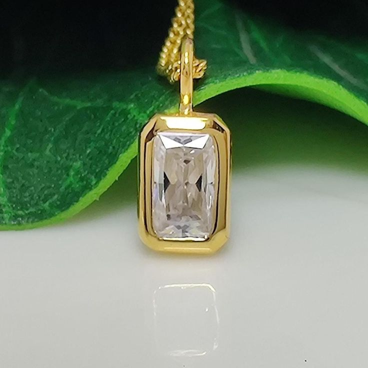 This elegant pendant features a 1.67-carat radiant-cut moissanite solitaire, showcasing its brilliant sparkle. The gemstone is bezel-set in 14k yellow gold, offering a secure and sleek design. This minimalist piece combines timeless charm with contemporary simplicity, making it a perfect accessory for women seeking a classic yet modern look. Bezel Set Moissanite Pendant 1.67 CT Radiant Cut Moissanite Solitaire Classic Pendant, 14k Yellow Gold Charm Minimalist Pendant For Womens Moissanite Pendan White Rectangular Jewelry With Single Diamond, Rectangular Yellow Gold Moissanite Jewelry, Square Cut Moissanite Jewelry For Gifts, Rectangular Moissanite Jewelry As A Gift, Rectangular Gold Moissanite Jewelry, Rectangular Moissanite Gold Jewelry, White Rectangular Moissanite Jewelry, Rectangular White Moissanite Jewelry, Minimalist Pendant