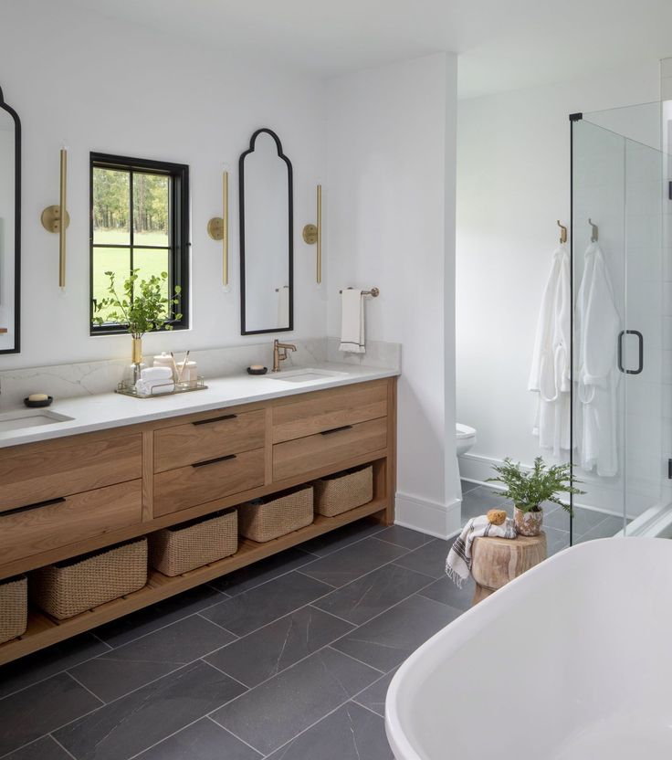 a large bathroom with two sinks and a tub