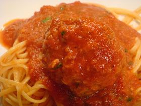 spaghetti and meatballs on a white plate