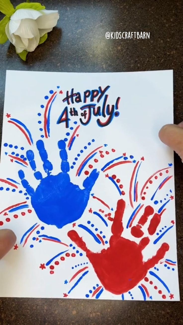 someone is holding up a handprinted fourth of july card