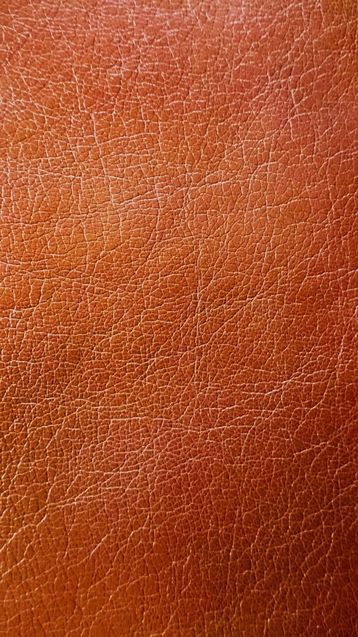 the texture of an orange leather material is shown in close up view with no image to describe