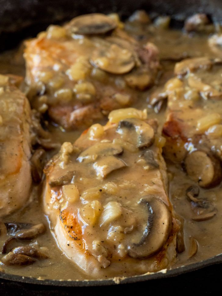 some meat with mushrooms and gravy in a skillet