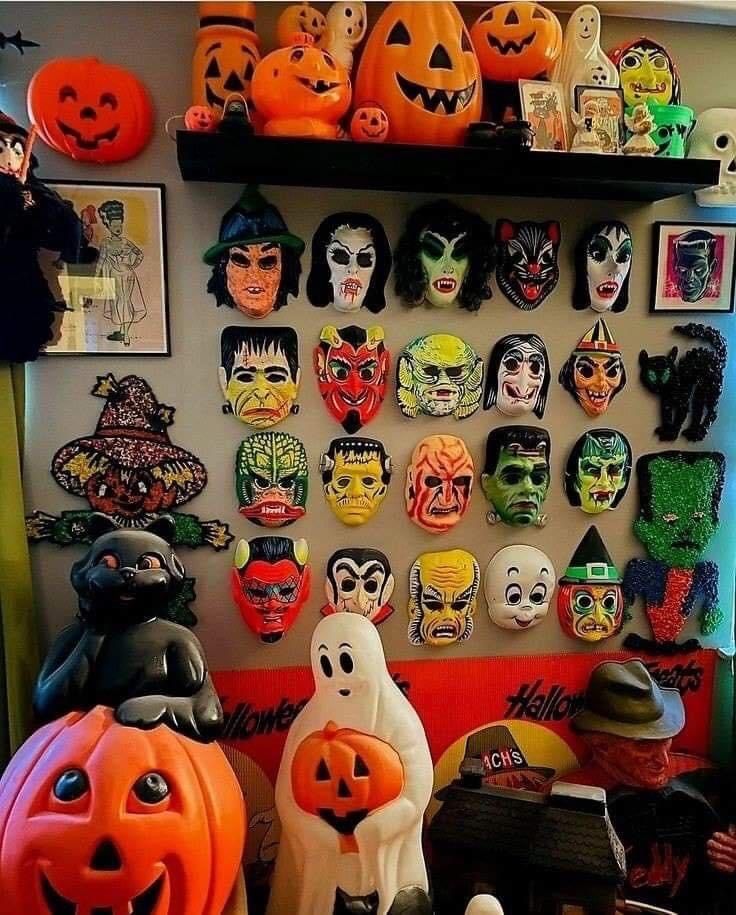 there are many halloween masks on the wall