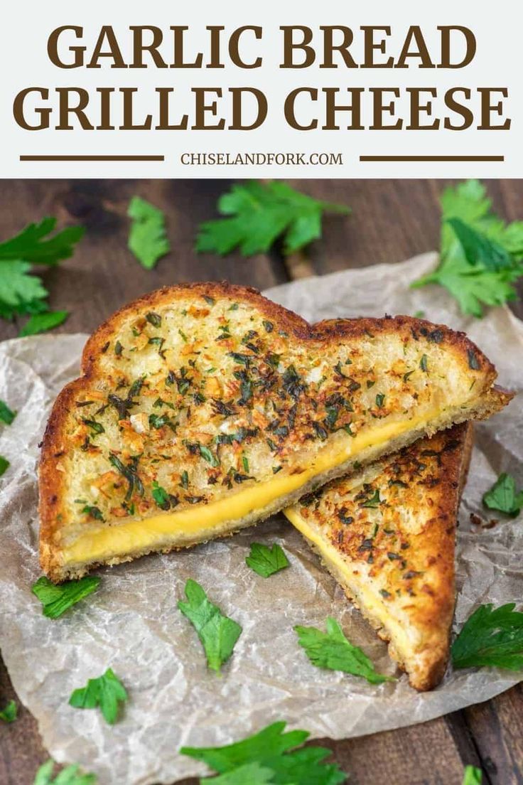 garlic bread grilled cheese sandwich cut in half on wax paper with parsley sprigs