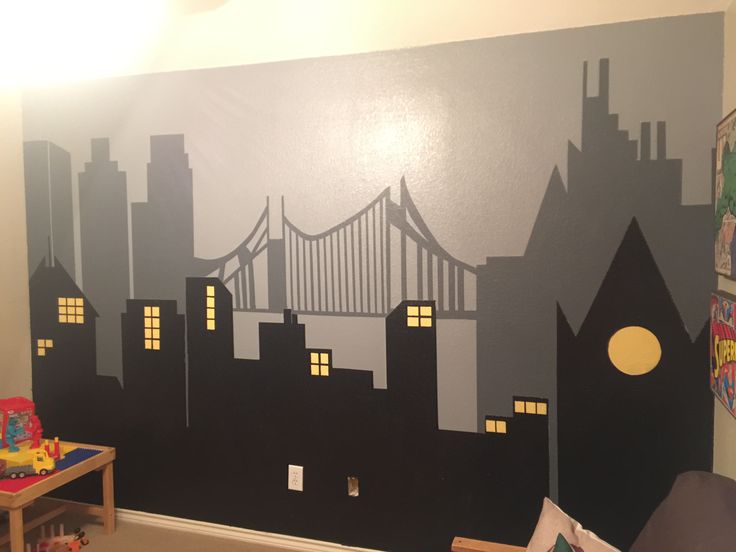 a child's room with a wall painted to look like a cityscape