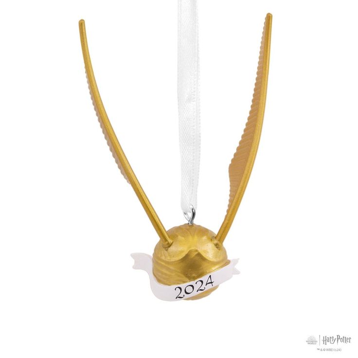 an ornament shaped like a golden bird with wings