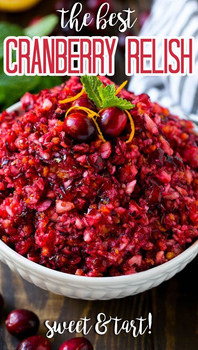 a white bowl filled with cranberry sauce and garnished with mint leaves