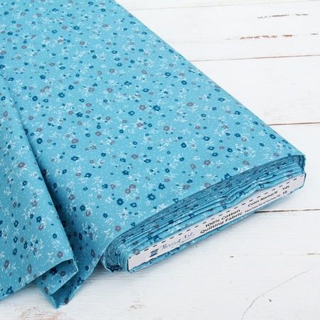 a close up of a blue cloth on a white wooden floor with wood planks in the background