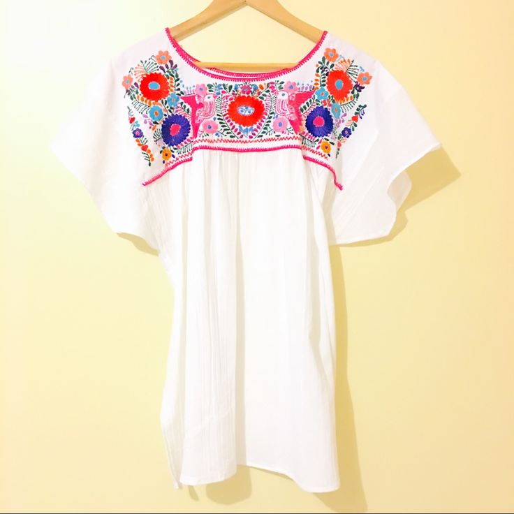 Mexican Traditional Embroidered Blouse Ethnic Boho Look Folk Art Measurements Bust: 23" Hips: 32" (Across) Handmade In Mexico Floral Embroidery Handstitched By Talented Artisans Ooak Unique In Every Piece. White Folk Peasant Top For Festival, White Peasant Dress With Embroidered Hem, White Folk Style Embroidered Dress, White Geometric Embroidered Short Sleeve Dress, White Short Sleeve Embroidered Dress With Geometric Pattern, White Short Sleeve Dress With Geometric Embroidery, White Embroidered Dress With Short Sleeves, White Folk Embroidered Top With Embroidered Hem, White Folk Embroidered Top For Festival