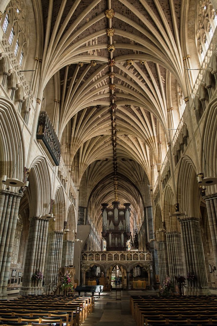 the interior of an old cathedral with pews