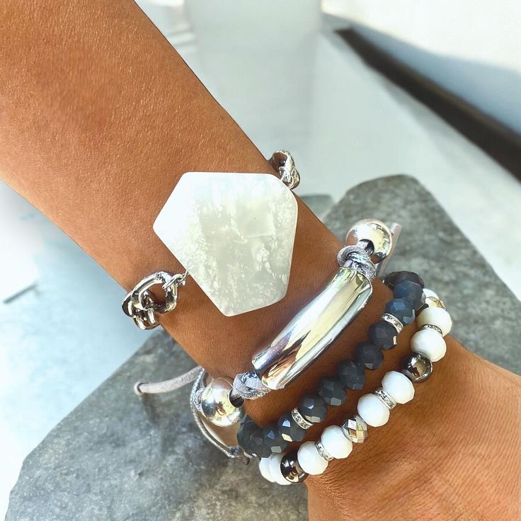 Elevate your style with this stunning bracelet set that combines modern elegance with boho chic vibes. The set features a striking white hexagon stone centerpiece, a sleek silver bar accent, and a mix of faceted beads in shades of black, white, and silver. Each bracelet is designed to be adjustable for a perfect fit and can be worn individually or stacked together for a layered look. Whether you're dressing up for a special occasion or adding a unique touch to your everyday outfit, this bracelet Adjustable Faceted Bohemian Crystal Bracelet, Adjustable Faceted Crystal Bohemian Bracelet, Bohemian Adjustable Faceted Crystal Bracelet, Bohemian Crystal Bracelet For Everyday, Bohemian Silver Wrap Bracelet With Faceted Beads, White Bohemian Stackable Crystal Bracelet, Bohemian Silver Faceted Beaded Bracelets, Bohemian Faceted Beads Bracelets For Everyday, Bohemian Bracelets With Faceted Beads For Everyday