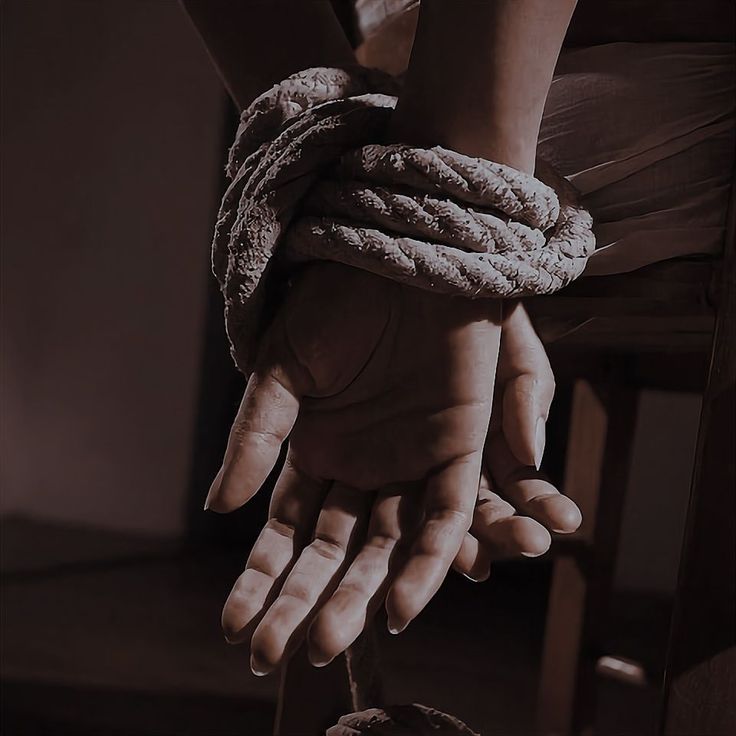 a person's hands tied up with rope