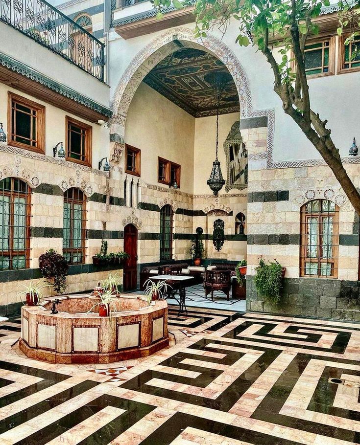 an artistic painting of a courtyard with black and white tiles on the floor, potted trees in the background