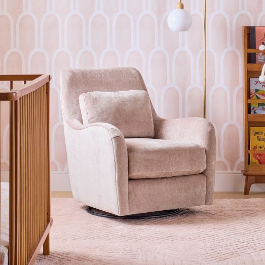 a baby's room with a rocking chair, crib and bookshelf