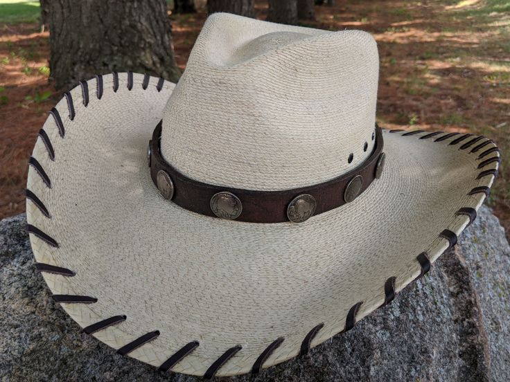 Replicated Buffalo Nickels feature the flip side of the coin. 11 Conchos on this hatband. Mounted on reconditioned horse tack. Ties on with leather lace and a deer antler bead. 23" long. Hat not included. Introduced in 1913, the Buffalo Nickel was an early hit with collectors and a major circulation workhorse through 1938 when the series ended. Although aficionados prefer the name Buffalo Nickel, the official name of the coin is the Five Cent Indian Head. The popularity of the Buffalo nickel is Rustic Adjustable Handmade Hat Bands, Classic Handmade Adjustable Hat Bands, Vintage Adjustable Hat Bands For Rodeo, Adjustable Vintage Hat Bands For Rodeo, Rustic High Crown Hat Band For Rodeo, Adjustable Country Hat Bands For Riding, Vintage Adjustable Hat With Leather Sweatband, Handmade Western Hat Bands For Western-themed Events, Adjustable Western Hat Band With Concho