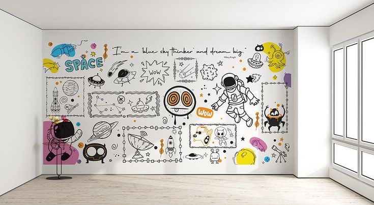 an empty room with white walls and colorful doodles on the wall, along with windows