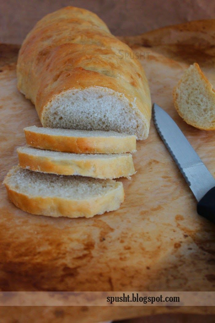 a loaf of bread sitting on top of a cutting board next to a knife