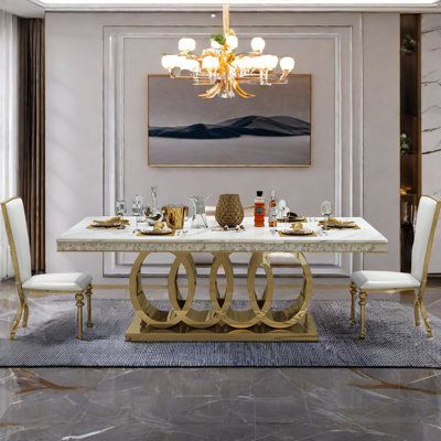 an elegant dining room with marble floors and white walls, along with chandelier