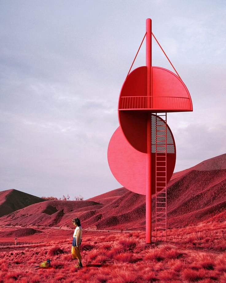 a woman standing in the middle of a field next to a tall red structure with a ladder