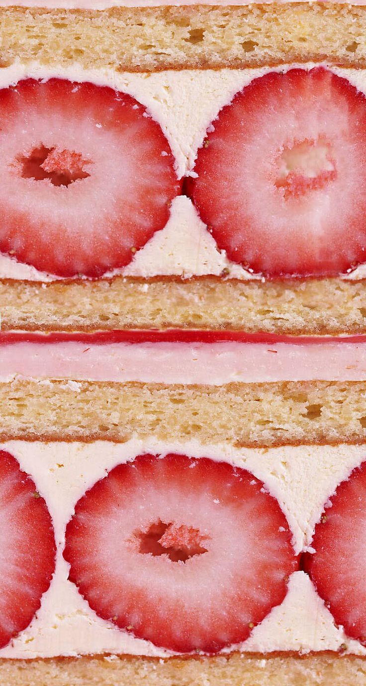 two slices of cake with strawberries on them