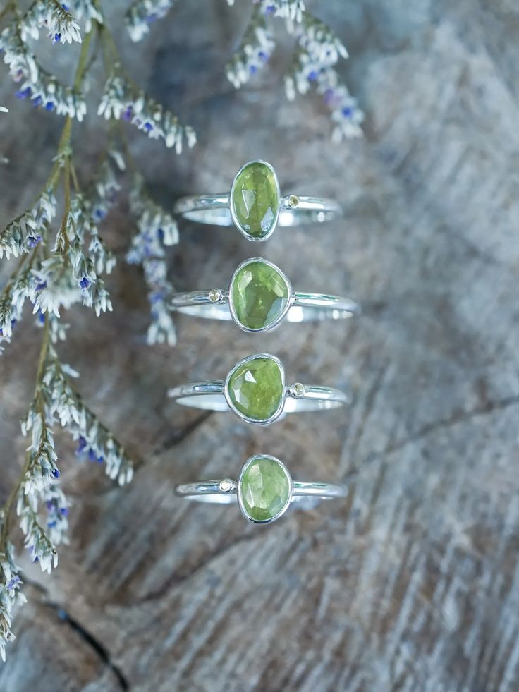 The rose cut peridot (August birthstone) shines alongside a tiny round green sapphire (September birthstone), both held securely in a bezel setting. Pair your peridot ring with peridot earrings to channel a free spirited and joyful vibe. Let this ring be the statement piece that adds a touch of whimsy and elegance to your style. Each piece of our jewelry is handcrafted with love. Peridot Ring Silver, Peridot Earrings, Ring Birthstone, Gold And Silver Rings, August Birthstone, Ethical Jewelry, Peridot Ring, Green Peridot, Green Sapphire