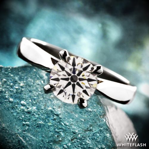 a diamond ring sitting on top of a rock