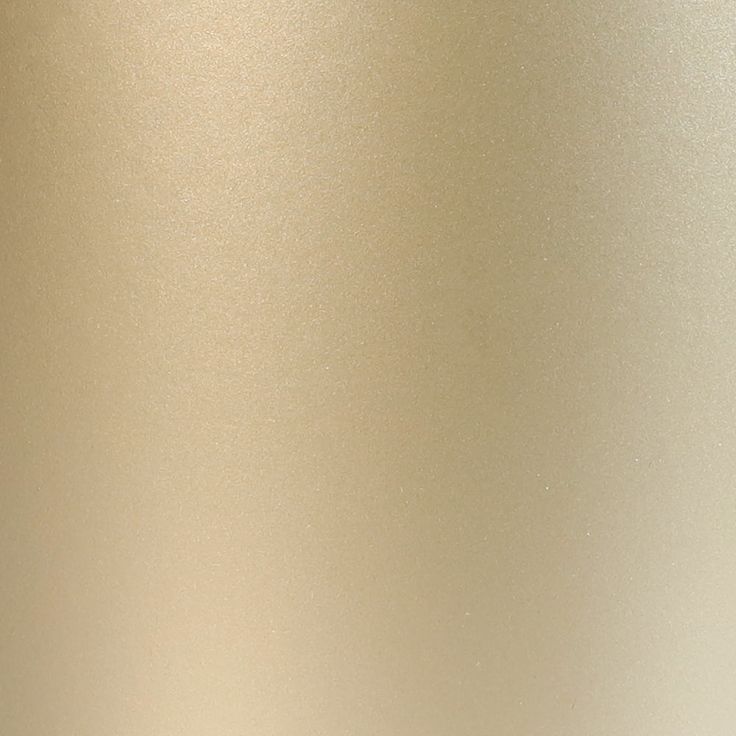 a close up view of the side of a gold colored metal object with white background