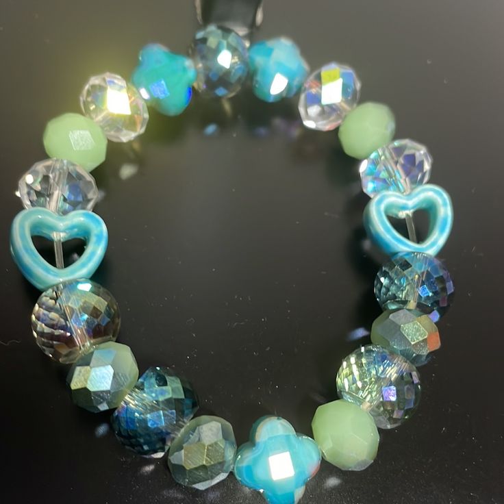 Crystal Handmade One Of A Kind Stretch Bracelet Blue Green With Ab Crystals And Heart Detail Handmade Light Blue Beaded Bracelets, Trendy Blue Beaded Bracelets For Party, Trendy Turquoise Bracelets For Party, Blue Adjustable Charm Bracelet For Party, Blue Charm Bracelet For Party, Adjustable Blue Charm Bracelet For Parties, Adjustable Light Blue Bracelets With Faceted Beads, Adjustable Blue Charm Bracelet For Party, Light Blue Adjustable Bracelet With Faceted Beads