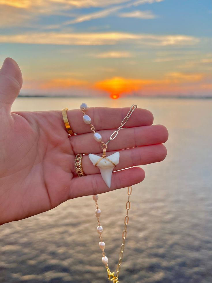 Freshwater Pearl beaded shark tooth necklace, perfect for wearing alone or for layering ✨ This necklace is Long-Lasting Plated it is about 16 inches long then it has a 18K gold plated lobster claw and extender allowing for adjustability half of the necklace is pearl and the other half is 14K gold plated oval link chain 🌊 the Pearl measures 4.5x5.5mm and the shark tooth on this necklace is a locally found unfossilized mako shark tooth. Cute Shell Necklaces, Shark Necklace Tooth, Gold Shark Tooth Necklace, Shark Tooth Necklace Aesthetic, Shark Tooth Jewelry, Shark Tooth Necklace Diy, Beaded Shark, Shark Accessories, Shark Stuff