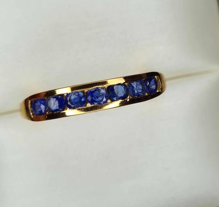 1.30ct Sapphire Half-Eternity Band Ring in 14K Gold Overlay 925 Sterling Silver UK  SIZE T Hallmarked 925 solid sterling silver with a genuine 14k yellow gold overlay Gives the look of a solid 14k gold ring  7 Blue Sapphire Round 3mm Faceted Cut 1.30ct  Please note the back of this band ring is thinner than the front to insure maximum comfort when bending your finger i have done my best to show this in the above pictures  Perfect as an everyday ring, engagement or wedding Anniversary Yellow Gold Sapphire Ring With Channel Set, Gift Sapphire Ring Channel Set, Yellow Gold Sapphire Ring With Channel Set For Gift, Yellow Gold Channel Set Sapphire Ring As A Gift, Channel Set Yellow Gold Sapphire Ring As Gift, Sapphire Ring Channel Set As Gift, Channel Set Sapphire Ring As Gift, Round Sapphire Ring With Channel Set For Anniversary, Gold Sapphire Jewelry With Channel Set