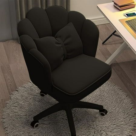 a black office chair sitting on top of a rug