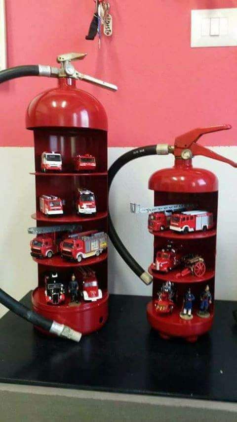 two red fire extinguishers sitting on top of a table