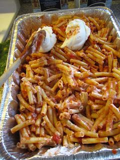 a pan filled with pasta and meat covered in sauce