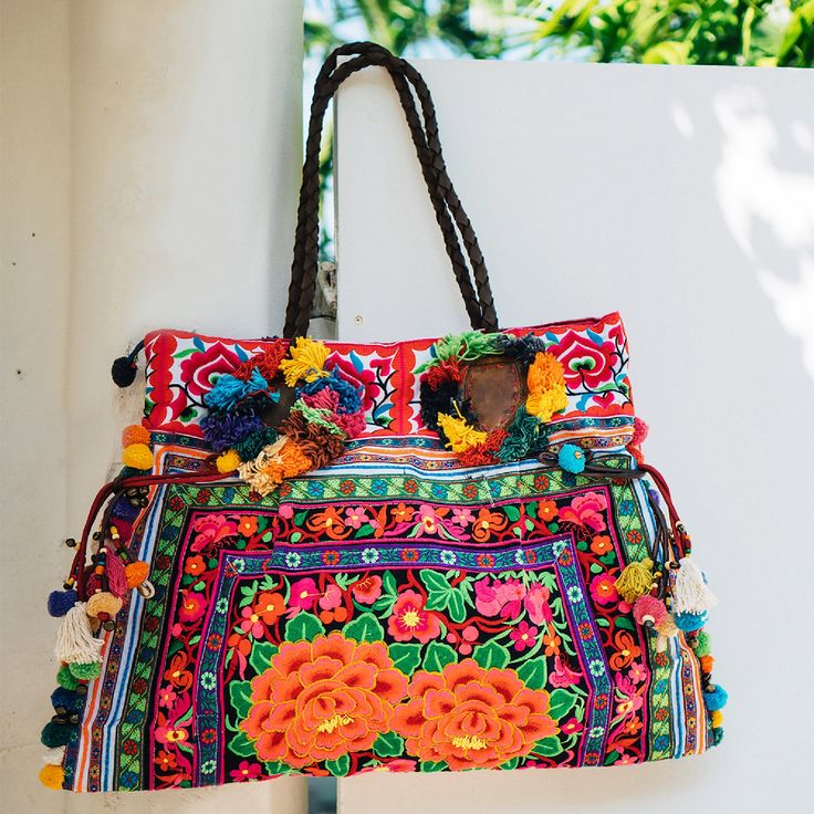 "This charming tote bag for lazy days at the beach and wandering around. It is made with an amazing piece of fabric woven by the HMONG hill tribes of Lanna Region (Northern Thailand). It features cotton lining, leather straps, a zipper closure and adorned with colorful hairs, pom poms. This bag will enhance your appearance. We buy materials from Hmong market and we design and sew by hand. Some of the bags we modify to improve the product. The Hmong tribes live in the North of Thailand and have o Sew By Hand, Boho Style Bag, Boho Tote Bag, Boho Tote, Embroidered Tote Bag, Bohemian Bags, Embroidered Tote, Mat Bag, Boho Purses