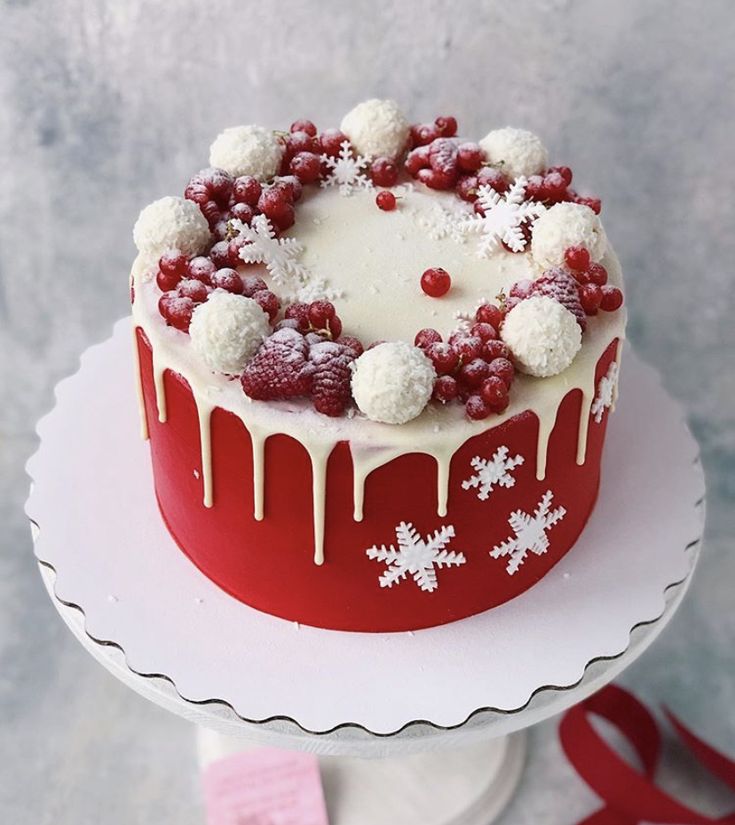 a red and white frosted cake sitting on top of a table