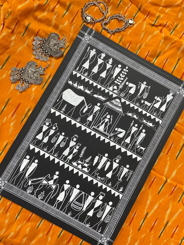 an image of some art work on a table cloth with scissors and other items around it