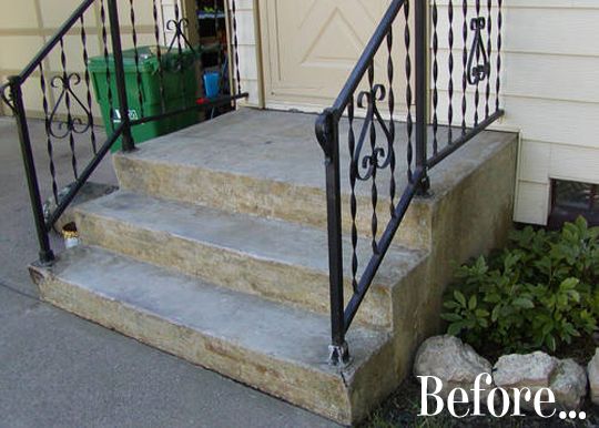 an iron stair railing on the side of a house