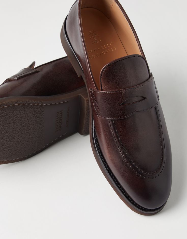 Calfskin penny loafers Casual lines and refined materials define the style of these calfskin Penny Loafers. Thanks to special finishing, the luxurious leather accentuates the season’s colors with slight color effects and a subtle natural grain. A rubber tread provides added comfort. Luxury Semi-formal Slip-on Moccasins, Luxury Goodyear Welted Tassel Loafers For Business, Luxury Leather Sole Tassel Loafers For Semi-formal Occasions, Luxury Semi-formal Tassel Loafers With Rubber Sole, Luxury Semi-formal Tassel Loafers With Leather Sole, Luxury Moc Toe Tassel Loafers For Business, Luxury Goodyear Welted Loafers For Galas, Luxury Wingtip Tassel Loafers For Semi-formal Occasions, Timeless Italian Monk Strap Shoes For Office