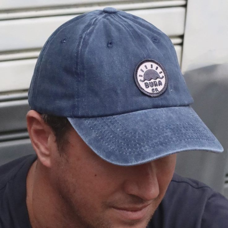 * Vintage style faded cotton dad cap * Unisex * Adjustable strap * Custom designed BURA woven patch on front * Perfect for outdoor adventures! Navy Adjustable Dad Hat For Outdoor, Casual Blue Baseball Cap With Logo Patch, Casual Outdoor Trucker Hat With Embroidered Patch, Blue Hats With Logo Patch And Curved Visor, Blue Hat With Logo Patch And Curved Visor, Blue Curved Visor Hat With Logo Patch, Adjustable Blue Baseball Cap With Logo Patch, Casual Blue Trucker Hat With Embroidered Logo, Casual Navy Baseball Cap With Logo Patch